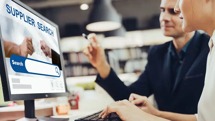 Diverse group of businesspeople reviewing supplier documents together